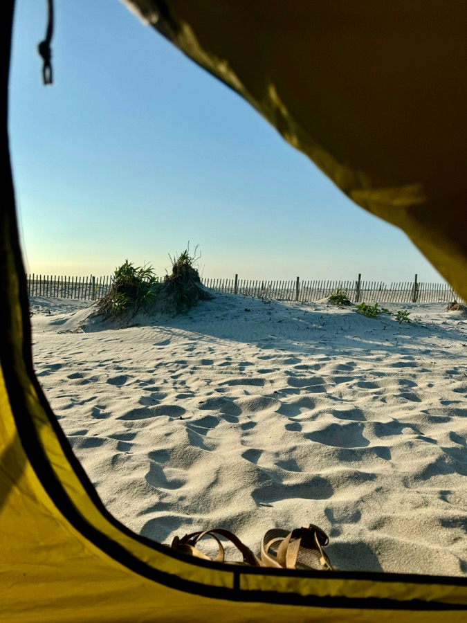 Tents beside a bright tropical beach